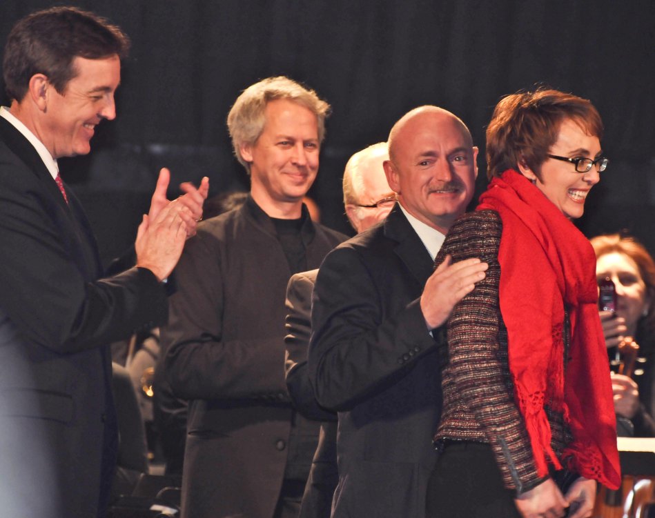 Escorted by her husband Mark Kelly