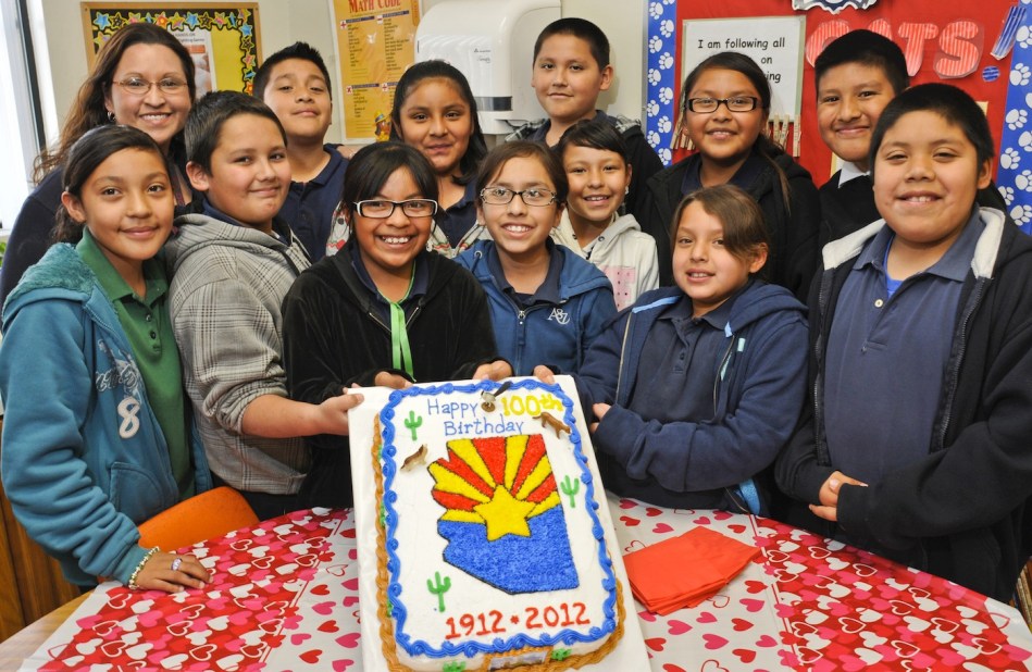 POSING WITH ARIZONA 100 YEARS OF STATE HOOD BIRTHDAY CAKE