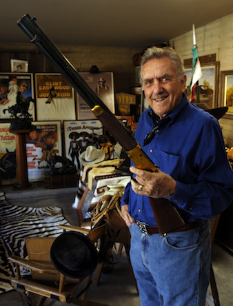 Robert Shelton holds a Winchester Centennial 30-30 rifle given to him by his former partner and friend John Wayne.