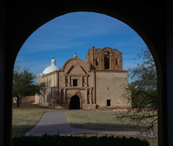 TUMCACORI NATIONAL MONUMENT The priest's first responsibility in founding a new mission was to build a church. When the Jesuits first arrived at Tumacacori, they held worship services in simple brush shelters and, eventually, replaced them with masonry, flat-roofed buildings. The largest and most elaborate of Tumacacori's churches was begun about 1800 by the Franciscan, Fray Gutierrez and the design was changed at least once before it was dedicated in 1822. Attempts were made to emulate the great cathedrals of Europe in many detail; the lime plaster of the entry was painted and grooved to resemble a stone arch: two side alters were constructed on each side of the nave and oval plaques displayed the Stations of the Cross. 