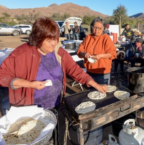 For breakfast Vonda Cassadore (left) and her friend, Kris Salaloa, work together to fry bread and tortillas for the hungry, growing camp of protestors.